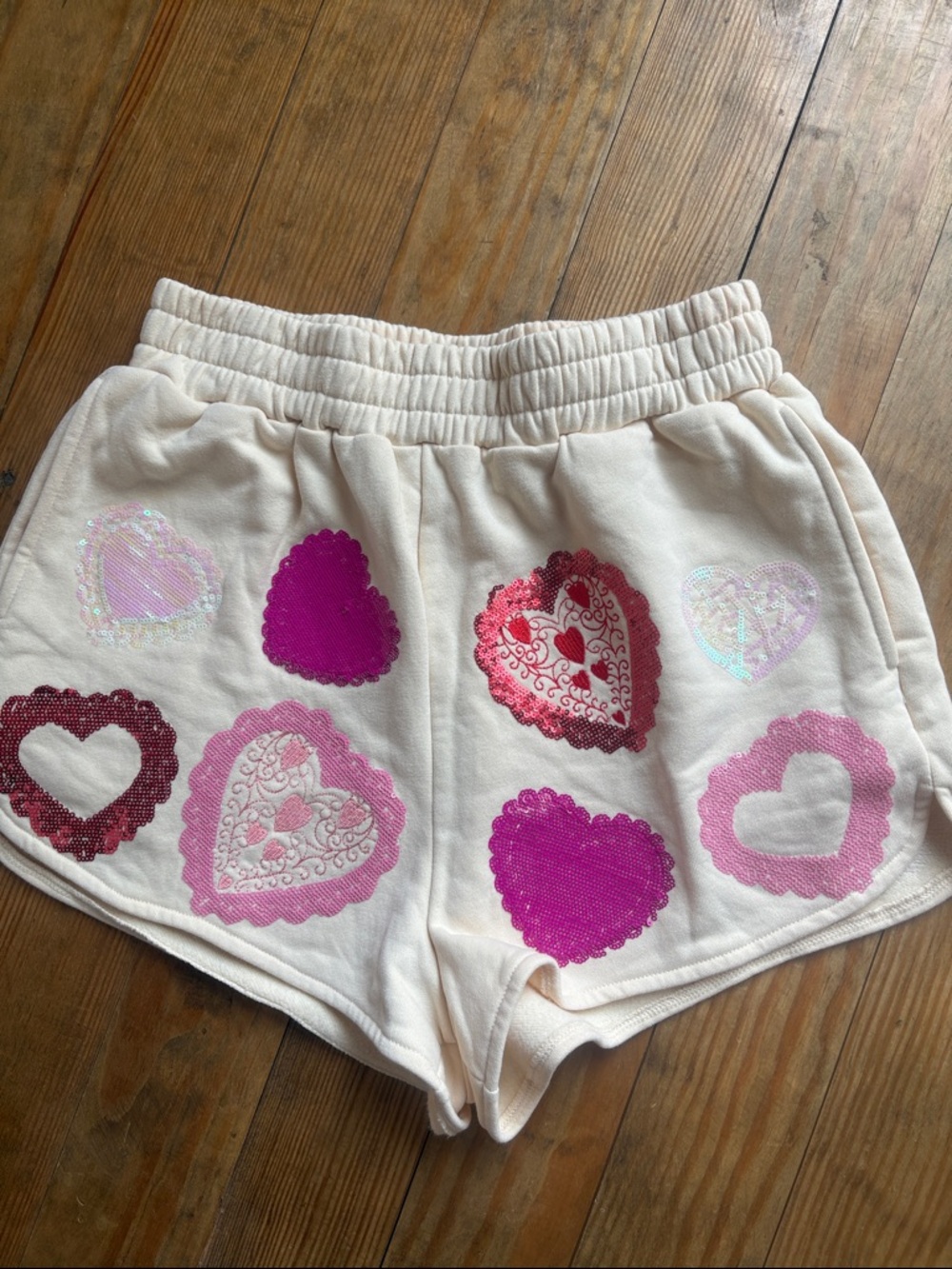 QUEEN OF SPARKLES Cream Knit Lounge Shorts with Pink Brand Tag